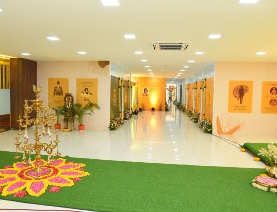 Beautifully decorated indoor entrance with draped curtains, floral garlands, and warm lighting, creating a welcoming spiritual ambiance.